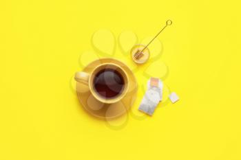 Composition with cup of tea on color background�