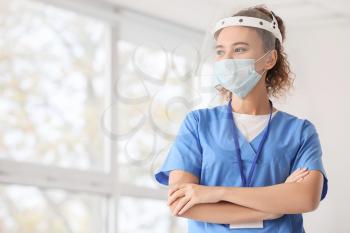 African-American female doctor wearing medical mask in clinic�