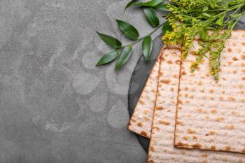 Jewish flatbread matza for Passover on grey background�