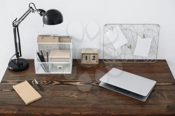 Modern workplace with organizer and laptop in room�