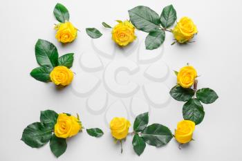 Composition with beautiful yellow roses on light background�