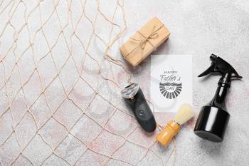 Composition for Father's Day with cosmetics and electric shaver on light background�