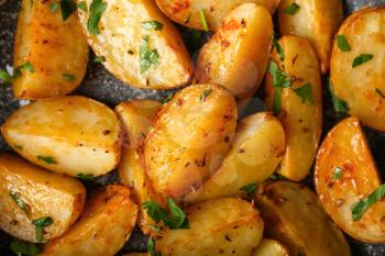 Tasty fried potatoes with parsley, closeup�