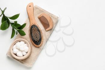 Hair brush, comb, towel and cotton balls on white background�