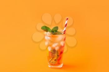 Glass of tasty ice tea with lemon on color background�