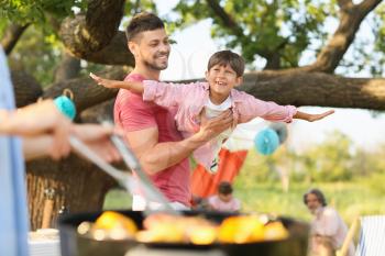 Happy family at barbecue party on summer day�