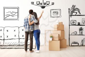 Young couple imagining interior of new house. Moving day�