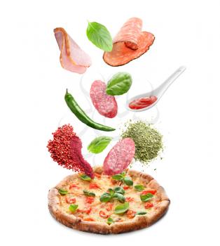 Tasty pizza with falling ingredients on white background�