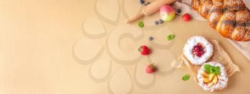 Sweet pastry and fruits on color background with space for text �