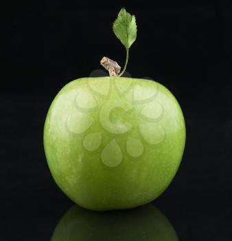 Green fresh Apple with  leaf on  black background