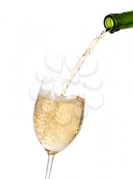White wine being poured into a wine glass.Isolated on white