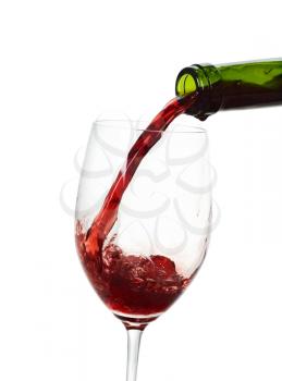 Red wine being poured into a wine glass.Isolated on white

