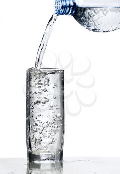 fresh water being poured into a  glass isolated on white