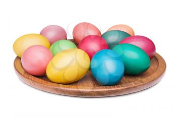 multicolored Easter eggs on the wooden plate isolated on a white background 