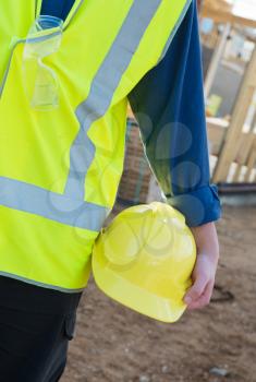 A young worker at the construction site with safety equipment