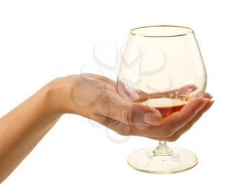 woman's hand with glass of brandy on white background
