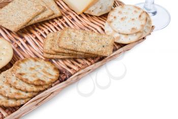 some crackers on the wicker plate  isolated on white background