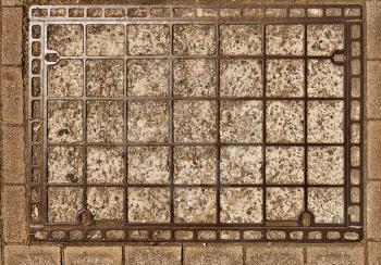 Old rectangular manhole cover as a grunge background