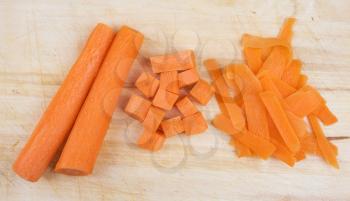 Chopped carrot for cooking on the rustic wooden board 
