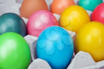 multicolored Easter eggs in the cardboard box
