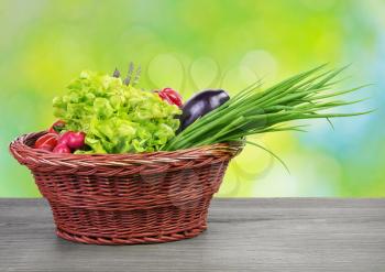 
Fresh organic vegetables in a basket on wooden vintage table