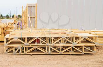 stack of wooden joists and building lumber at construction cite 