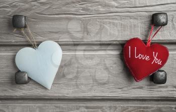 Hard and soft hearts-two hearts on vintage wooden background