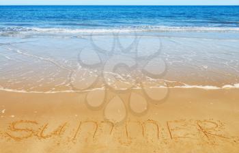 Summer message on the beach sand - vacation and travel concept