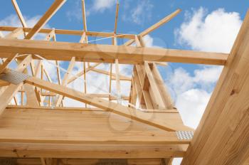 New residential construction home framing against a blue sky.Shallow focus.