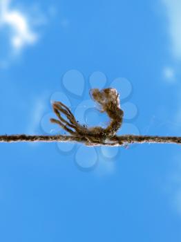 Royalty Free Photo of a Knotted Rope Against Blue Sky