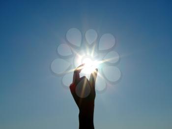 Royalty Free Photo of a Female Hand Measuring the Sun