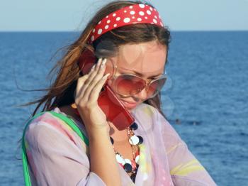 Royalty Free Photo of a Woman on a Phone Beside Water