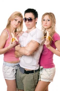 Royalty Free Photo of a Boy With Two Girls Eating Bananas