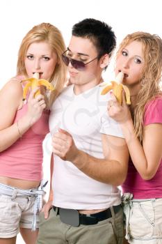 Royalty Free Photo of Two Girls Eating Bananas With a Boy