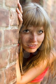 Royalty Free Photo of a Woman at a Brick Wall