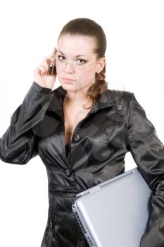 Royalty Free Photo of a Woman in Black Holding a Laptop and Talking on the Phone