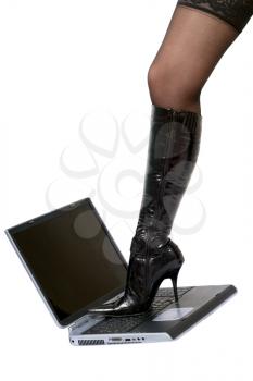 Royalty Free Photo of a Woman's Leg and High Heel on a Laptop
