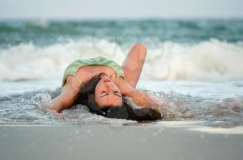 Pretty young woman lying on the beach