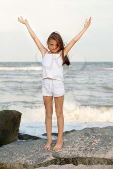 Cute cheerful little girl on the beach