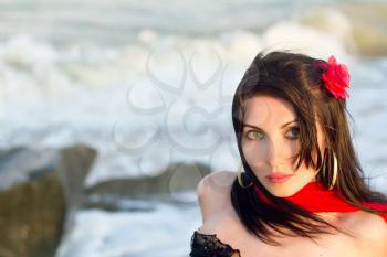 Closeup portrait of lovely young brunette on the beach