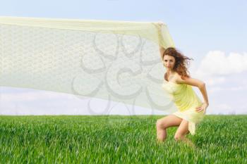 Charming young woman in a green field