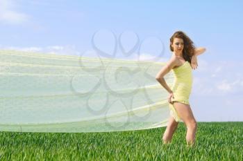 Young beautiful woman in a green field 