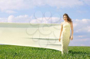 Young attractive woman in a green field 
