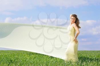Young gorgeous woman in a green field 
