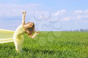 Charming flexible young woman wrapped in yellow cloth   