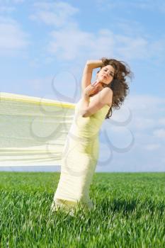 Young nice woman wrapped in yellow cloth