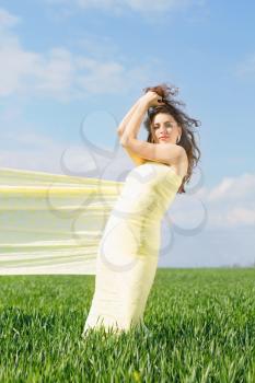 Young perfect woman wrapped in yellow cloth