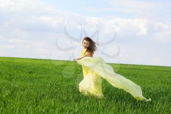 Cute young woman in a green field