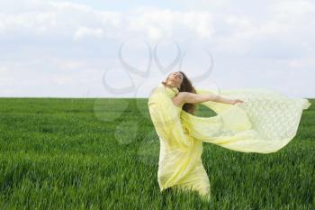 Nice expressive young woman in a green field