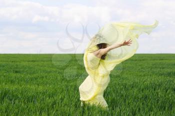 Perfect expressive young woman in a green field